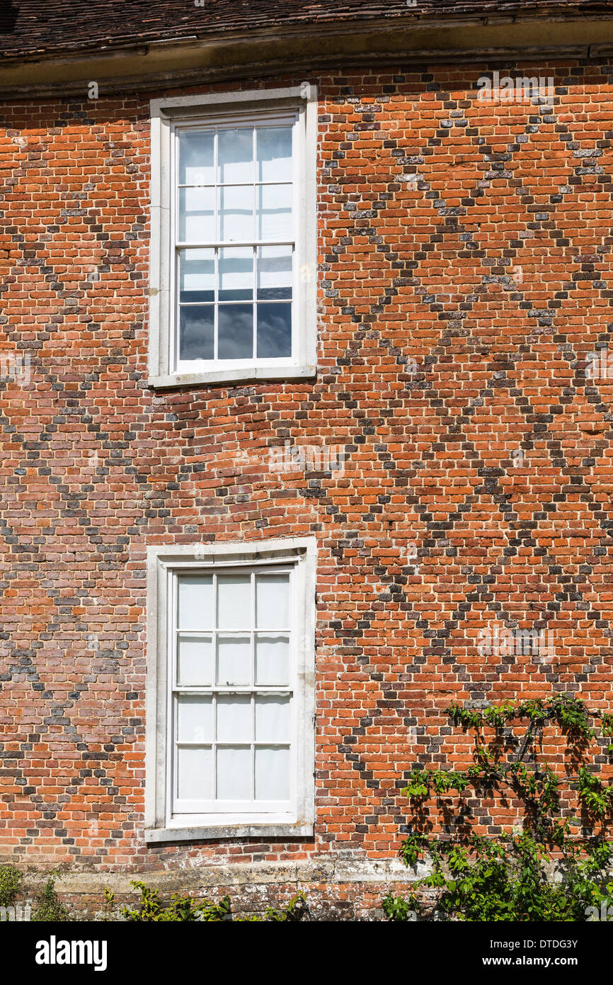 Tudor Windows tudor windows and brickwork with diamond pattern on a wall at the Tudor Windows tudor windows and brickwork with diamond pattern on a wall at the