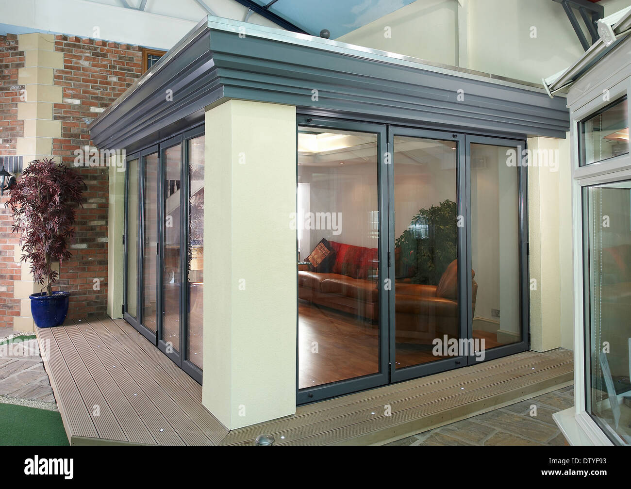 A series of images showing folding doors in varying stages on an ... A series of images showing folding doors in varying stages on an ...