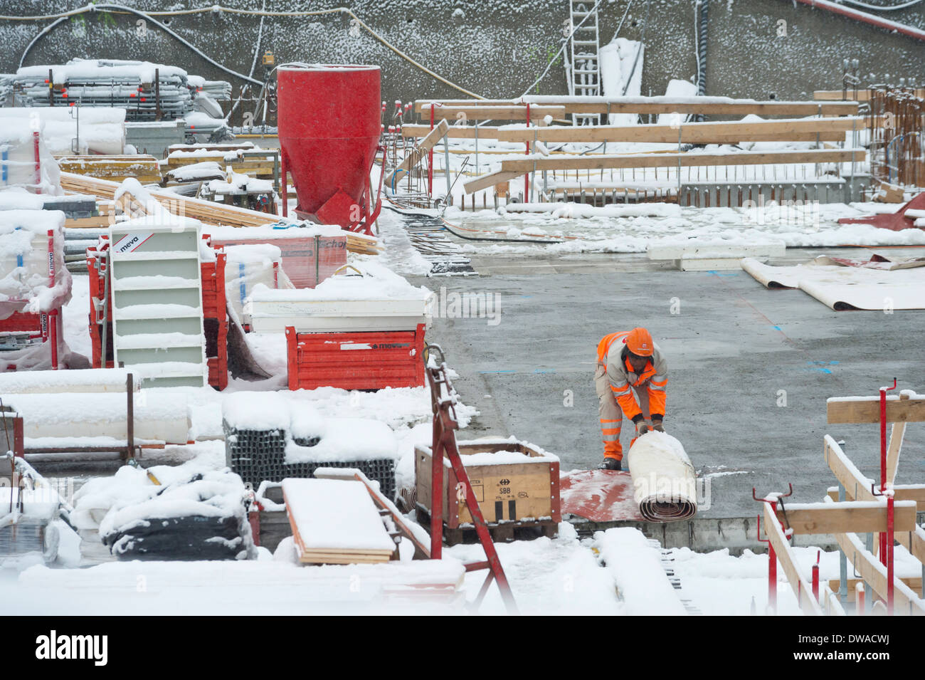 Construction workers and building activity on a snowed winter Stock