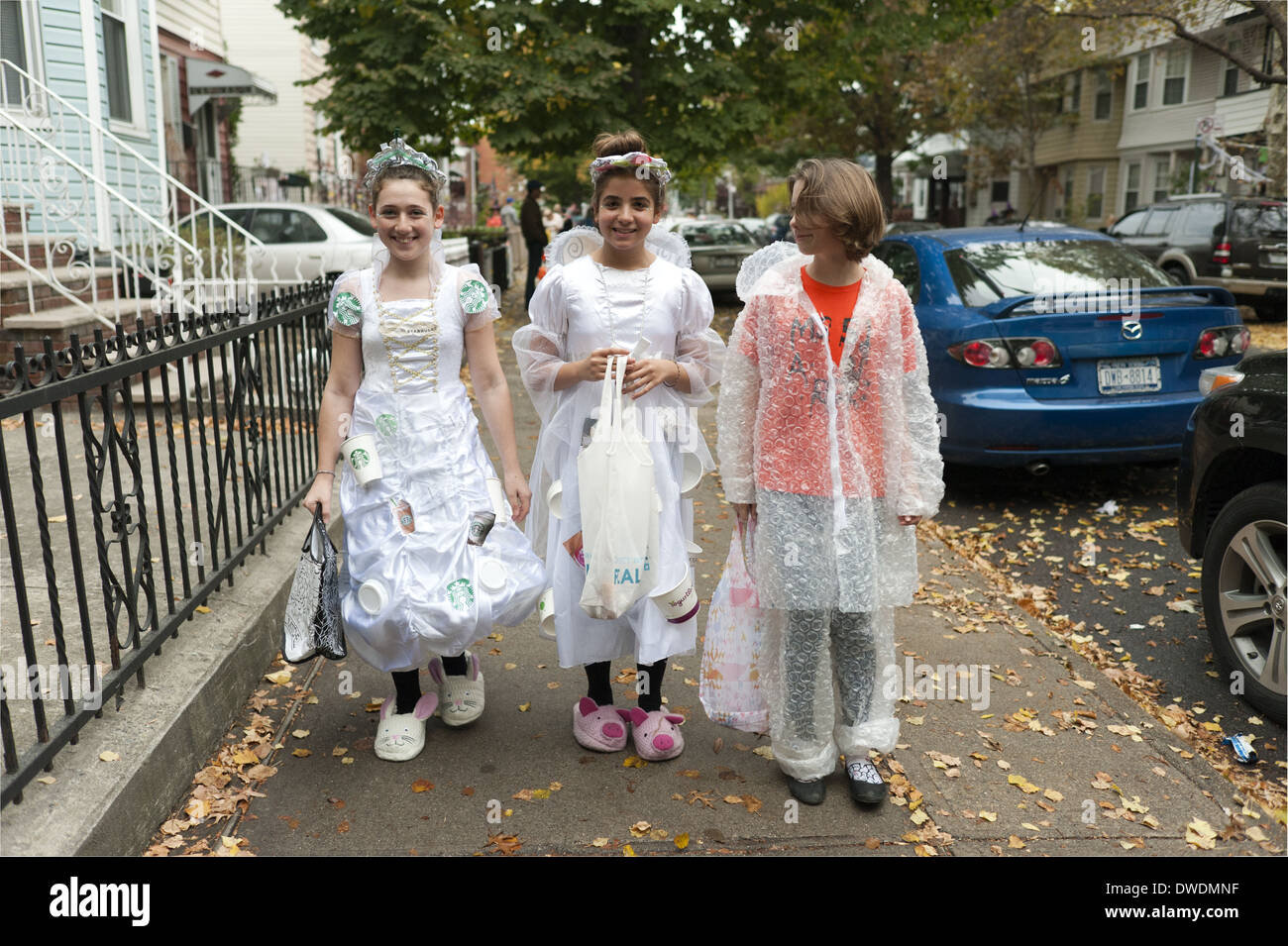 Halloween trick or treaters in the Kensington section of Brooklyn, NY. Girls dressed in costumes made from recycled materials.