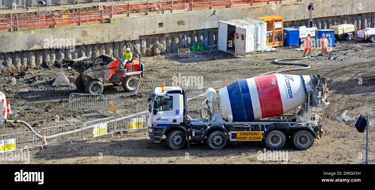 Ready mixed concrete delivery lorry and dumper truck on construction