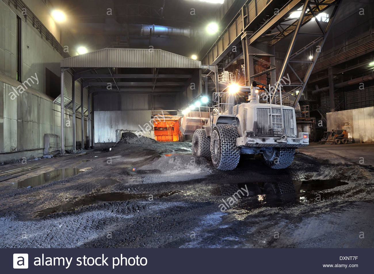 Germany, Steel mill, removal of slag with shovel excavator Stock Photo