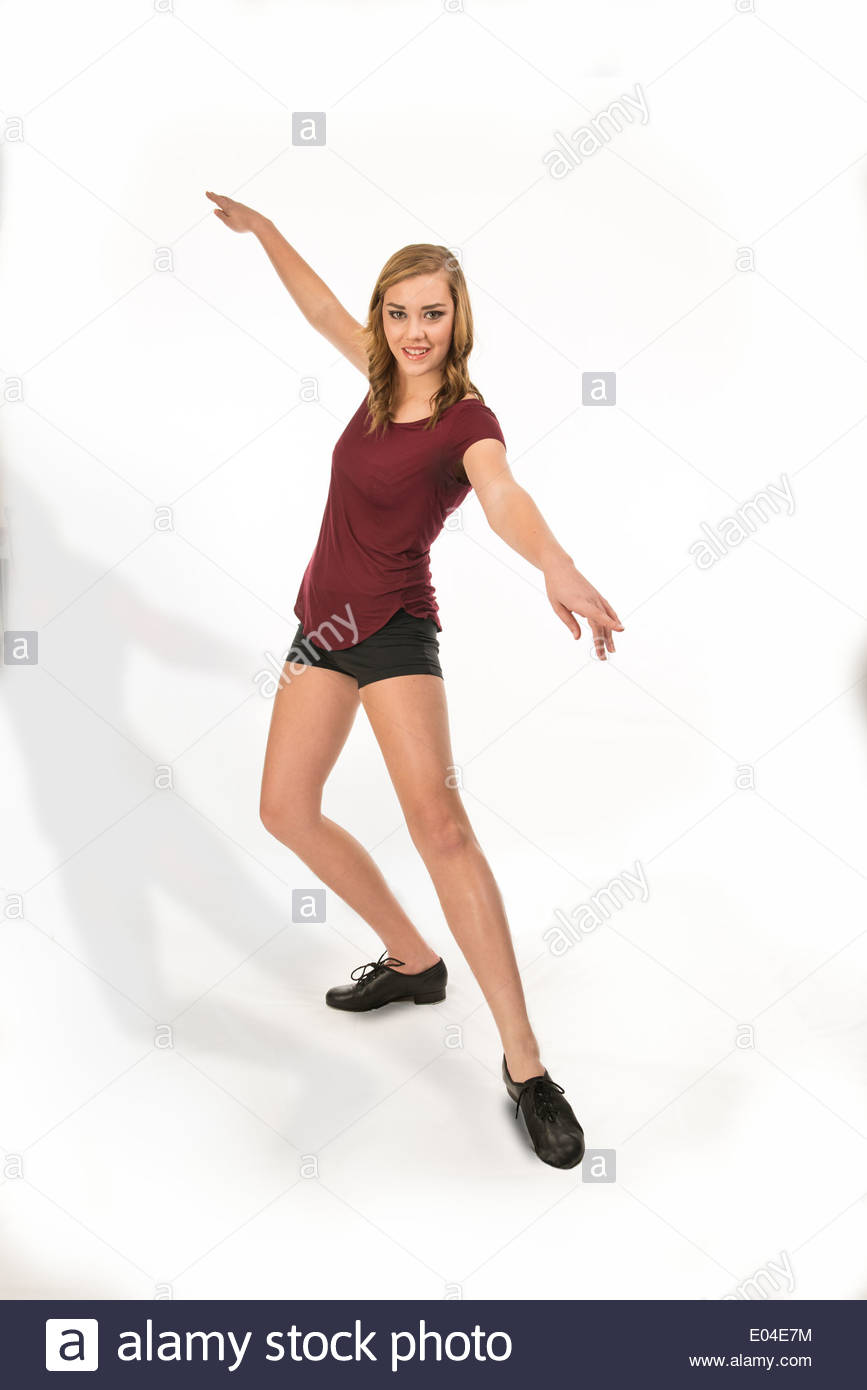 young teen girl tap dancer on a white background in shorts and a Stock Photo, Royalty Free Image