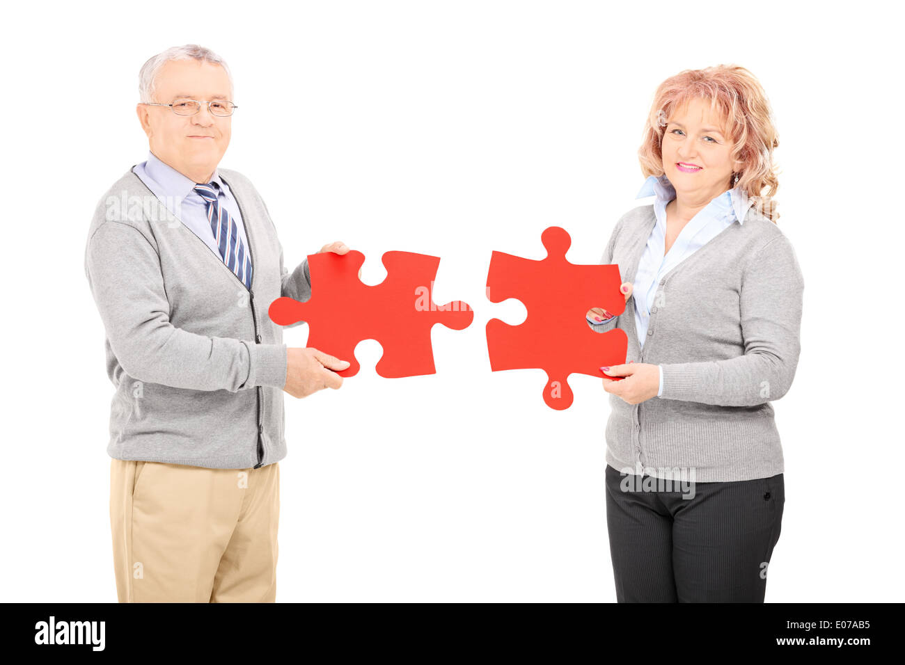 Mature Couple Holding Two Pieces Of Puzzle Stock Photo Alamy