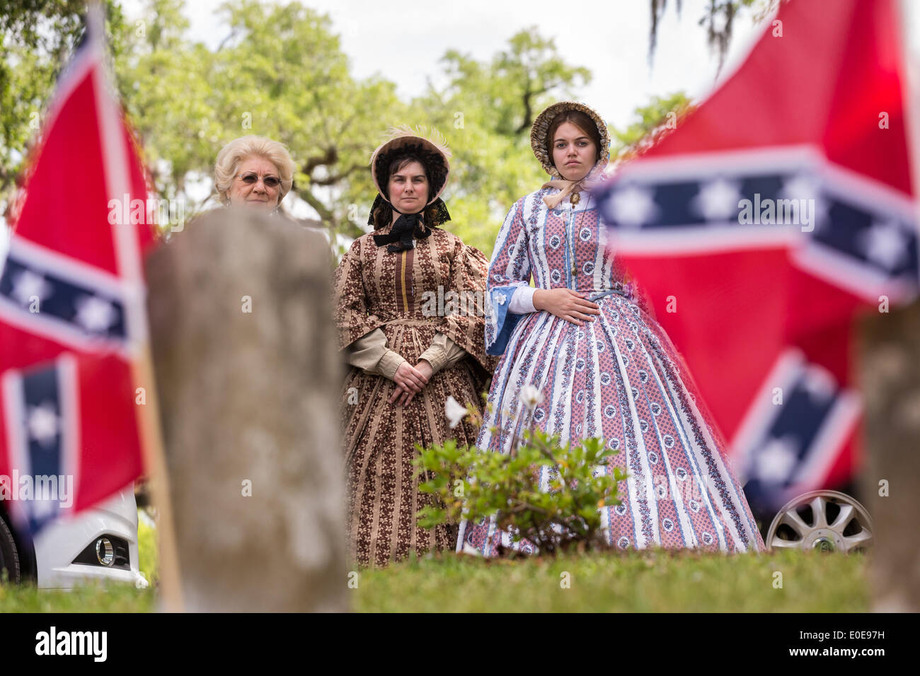 Reenactors dressed in Civil War era hoop skirts stand at during Stock