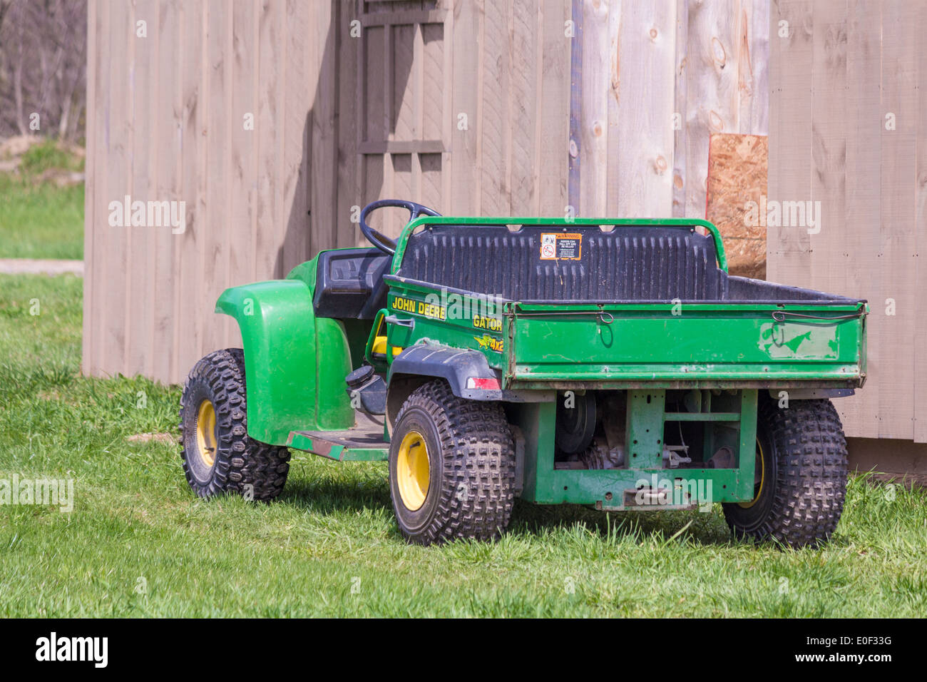 John Deere Gator 4x2 tractor with attached dump wagon Stock Photo