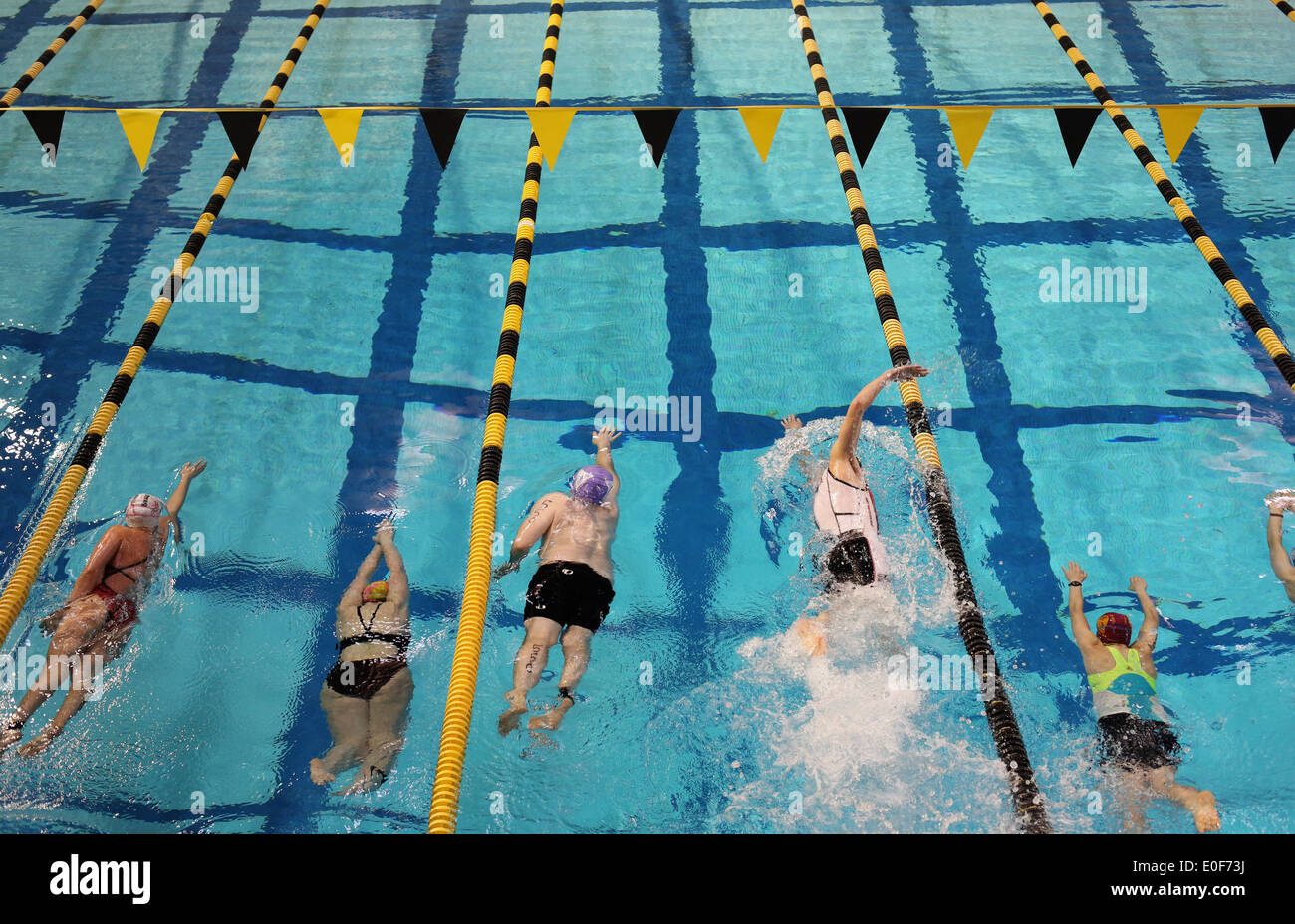 People swimming laps in a pool during a triathlon competition Stock
