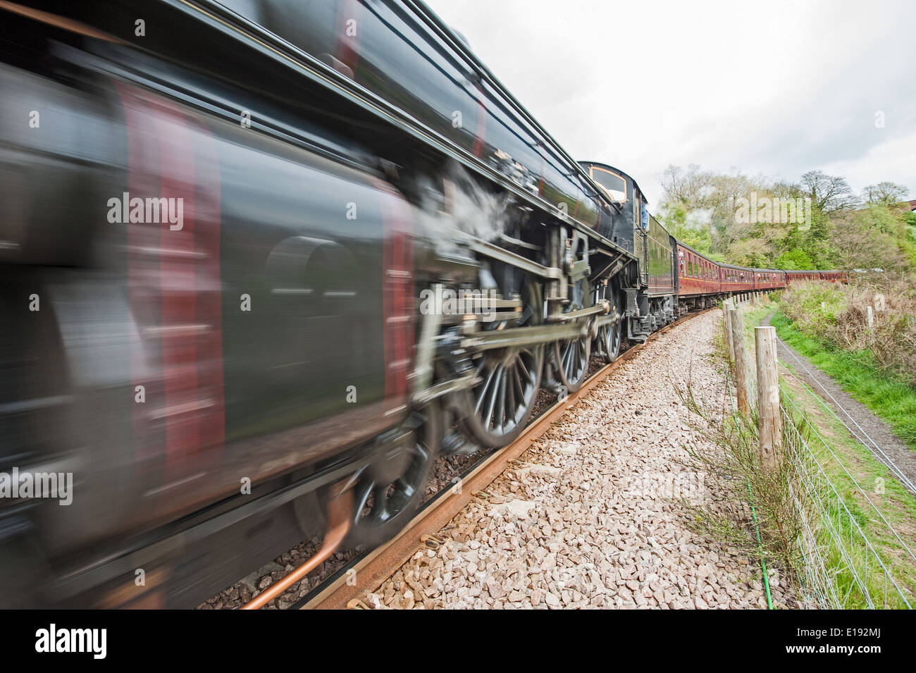 Old English Steam Train Travelling Along Tracks Through Rural