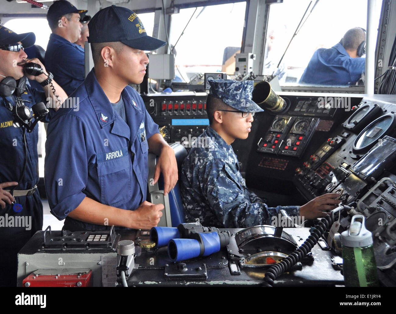 U.S. Navy Boatswain's Mate 3rd Class Jerome Arriola, center, and Stock