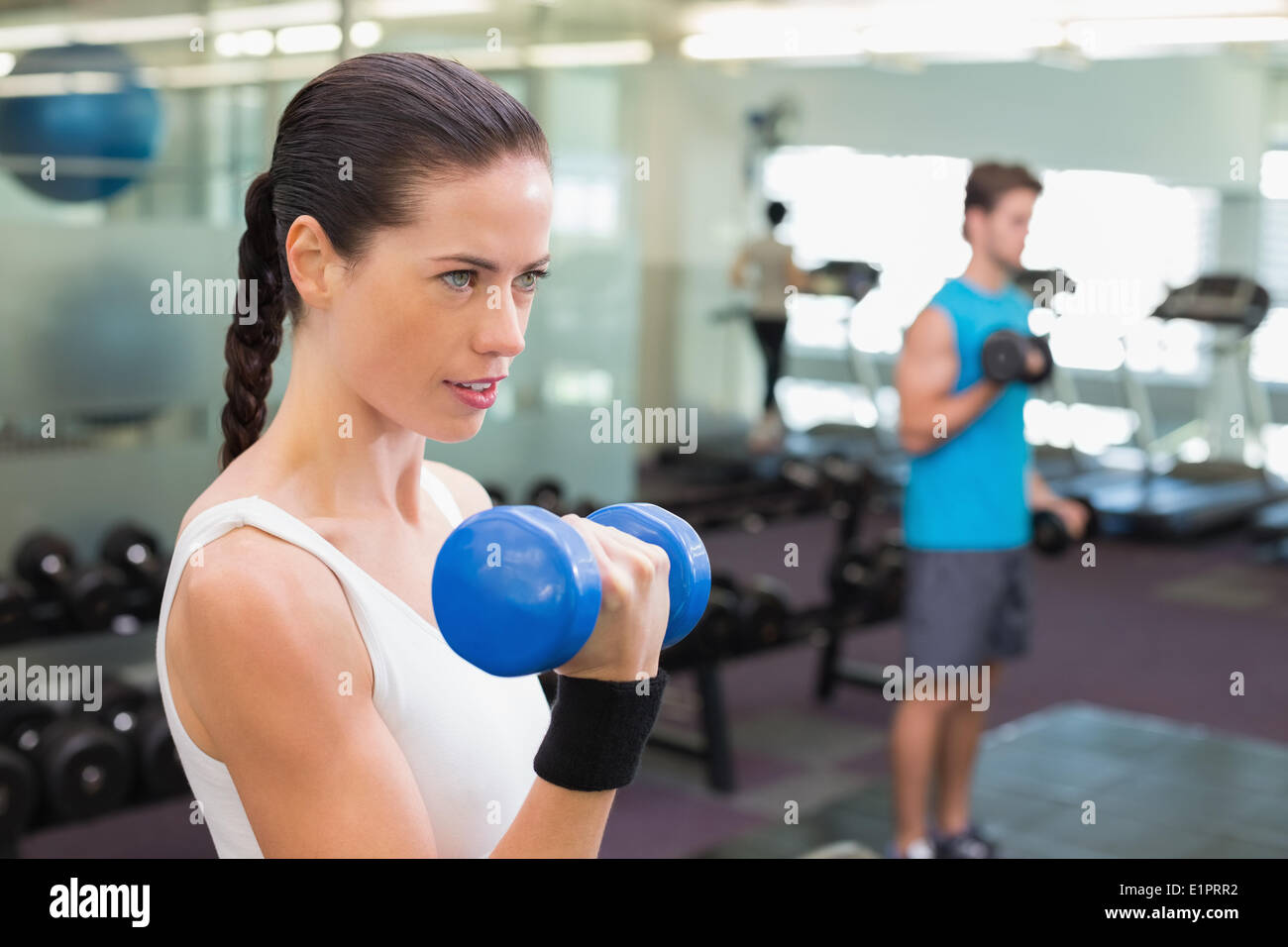 Fit Brunette Lifting Blue Dumbbell Stock Photo Alamy