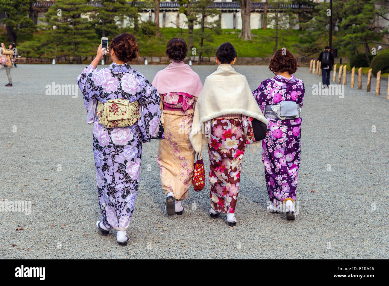 Four Japanese women in traditional dress walking in Kyoto Imperial