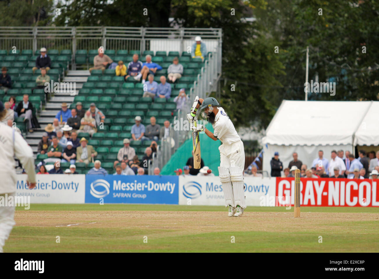 Men playing cricket at a match during the Cheltenham Cricket festival