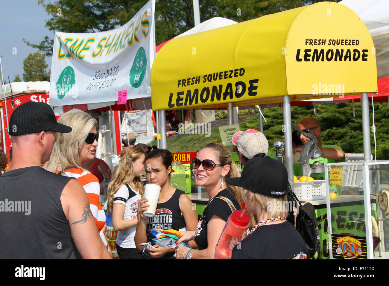 Fresh Squeezed Lemonade concession stand with people in front Stock