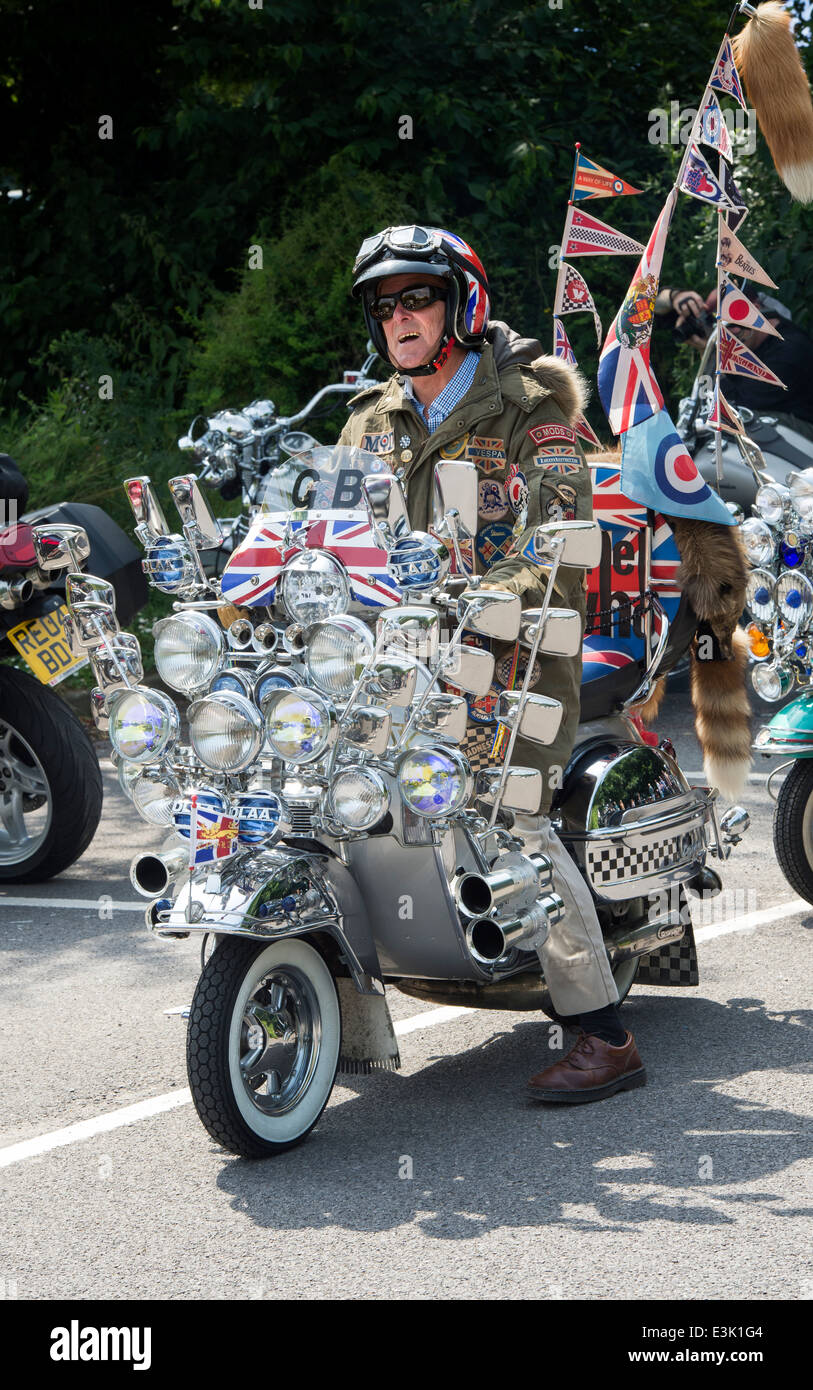 Old Mod Riding On His Vespa Custom Scooter With Mirrors Lights Logos And Union Jack Decal Old Mod Riding On His Vespa Custom Scooter With Mirrors Lights Logos And Union Jack Decal