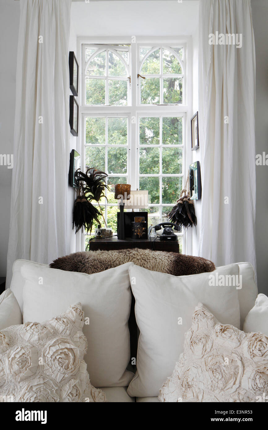 White Sofa In Front Of Window With Wooden Venetian Blind In Modern White Sofa In Front Of Window With Wooden Venetian Blind In Modern