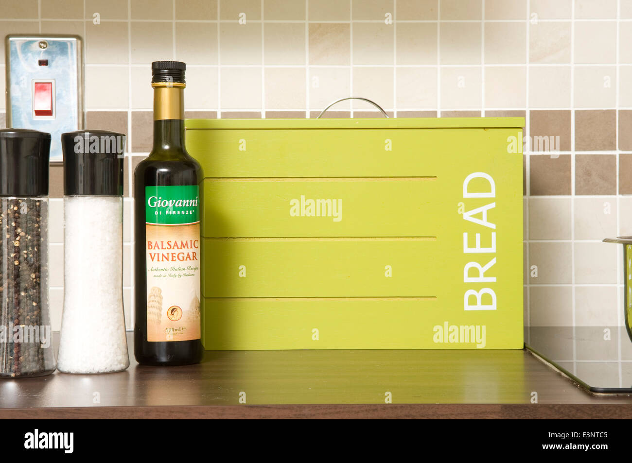 Salt and pepper pots next to bread bin on kitchen worktop Stock Photo