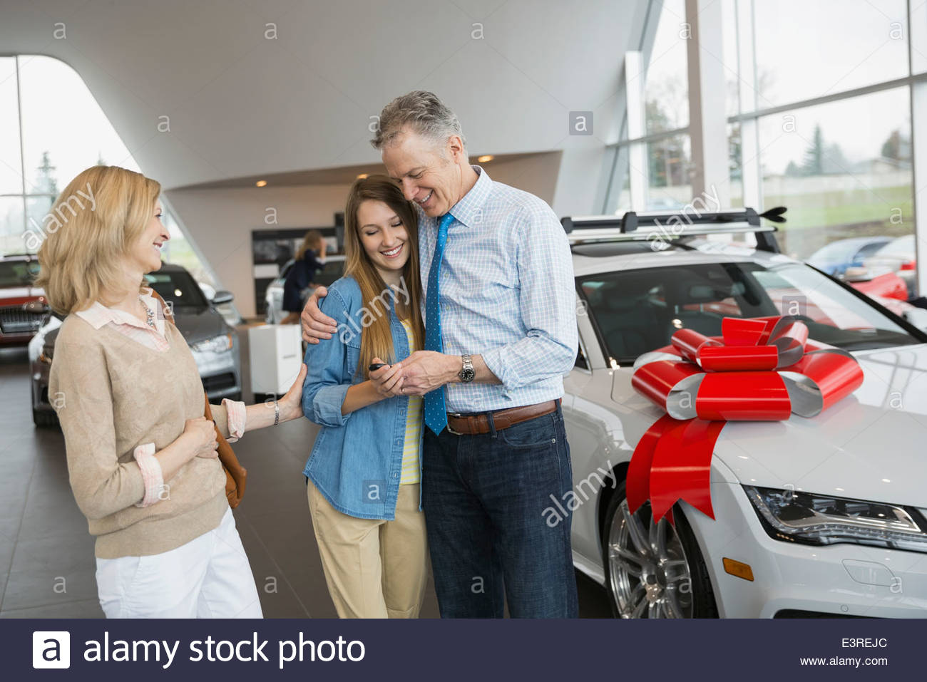 Parents buying daughter car in dealership showroom Stock Photo, Royalty Free Image 71201828 Alamy