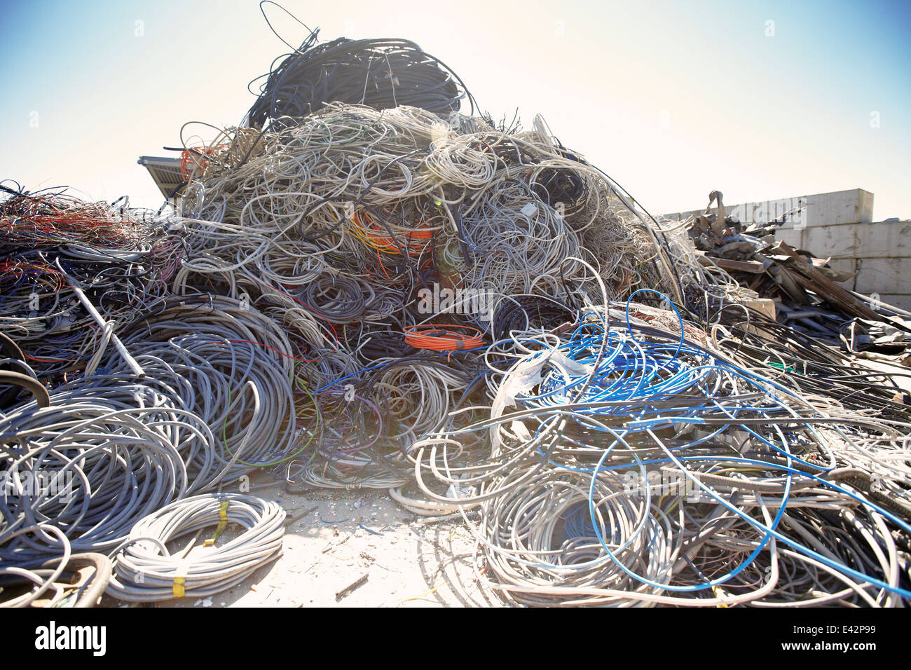 Heap of coiled and tangled cables in scrap metal yard Stock Photo