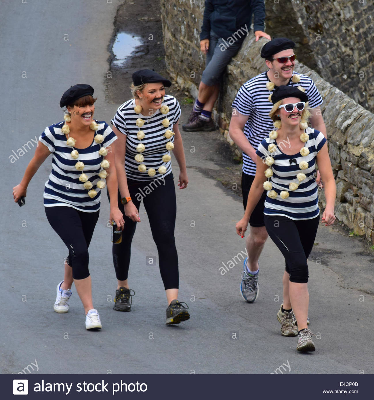 Man and three women dressed in 'French' striped tops, red scarves and