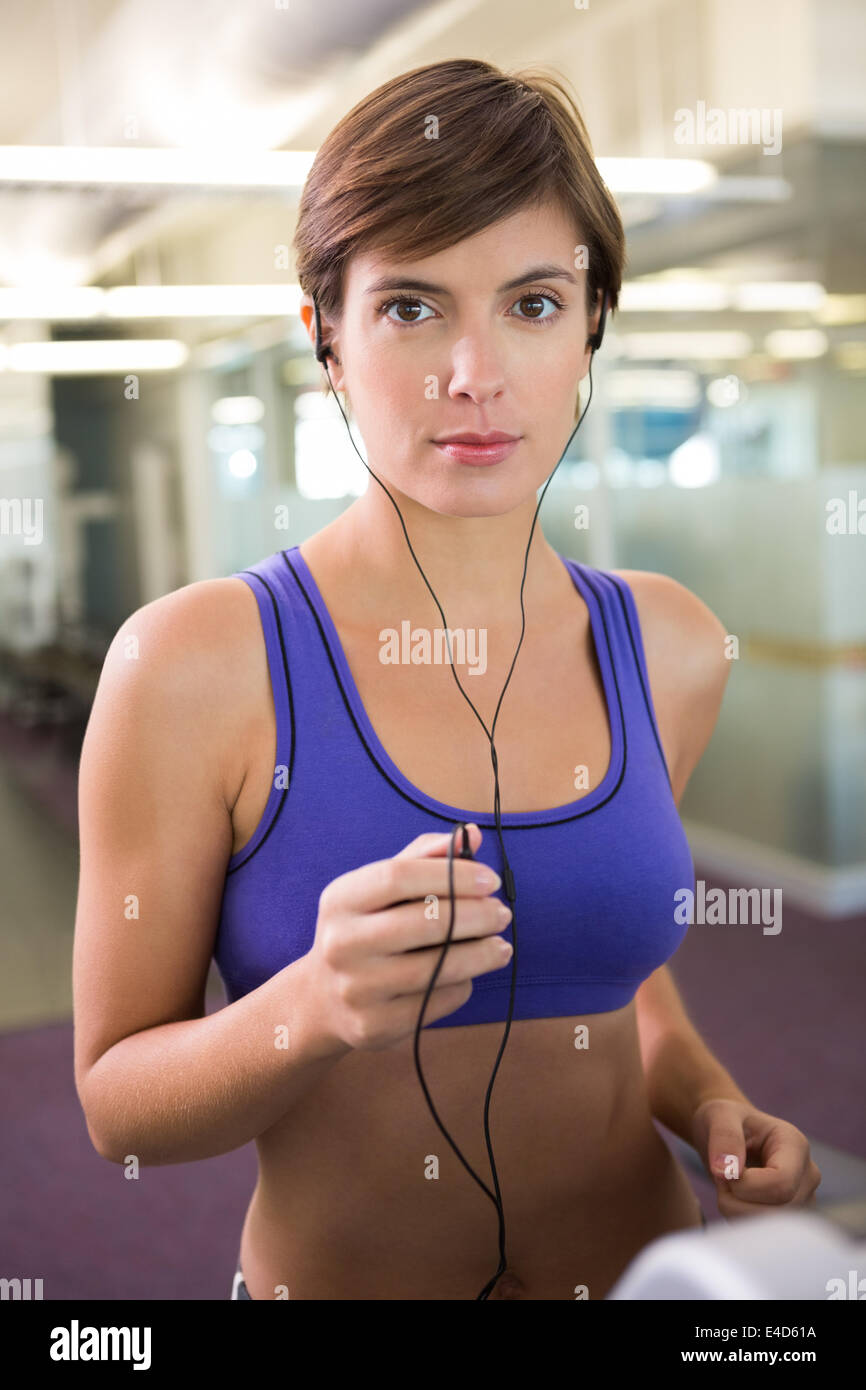 Fit Brunette Running On The Treadmill Listening To Music Stock Photo Alamy