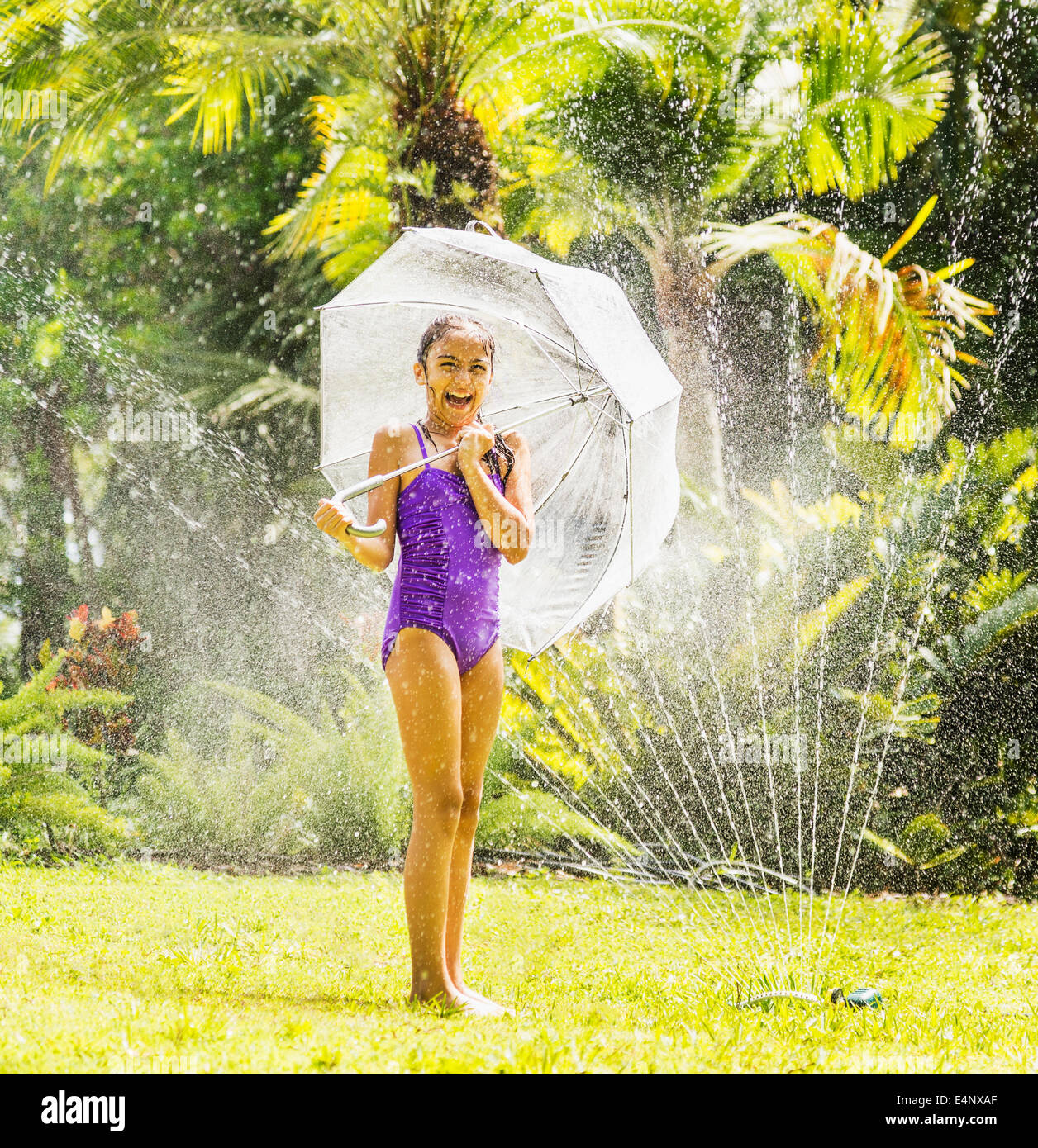 Girl 8 9 Playing In Sprinkler Stock Photo Alamy