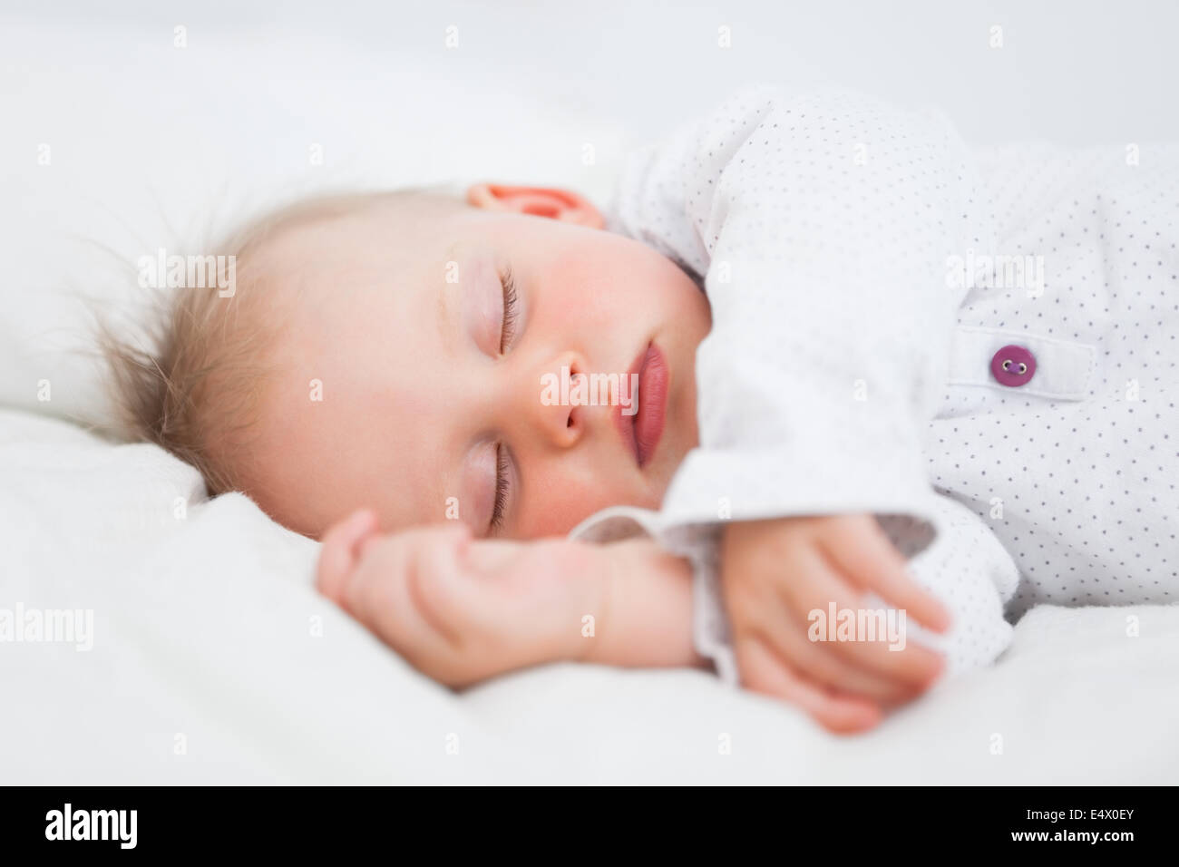 Cute Baby Sleeping While Extending Her Arms Stock Photo, Royalty Free