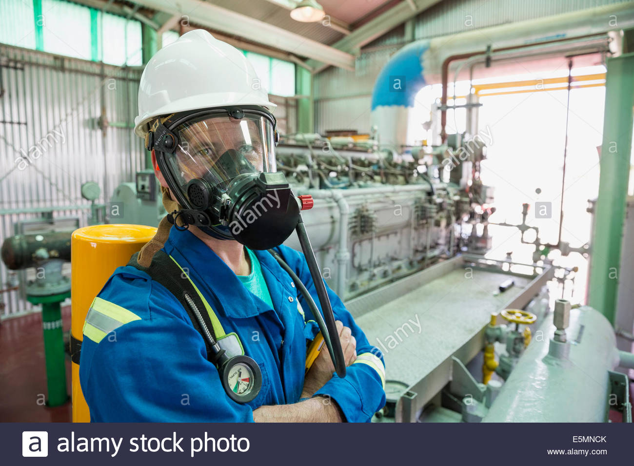 Male worker wearing respirator in gas plant Stock Photo, Royalty Free