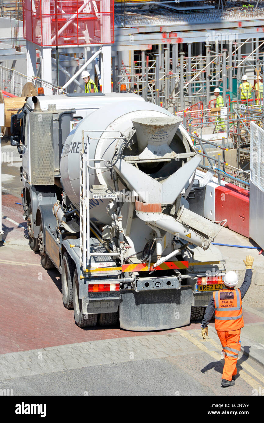 Traffic Marshall directing a reversing ready mix concrete lorry from