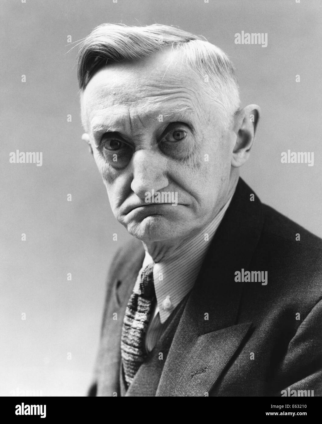 1930s-1940s-senior-elderly-man-with-grim-serious-facial-expression-E63210.jpg