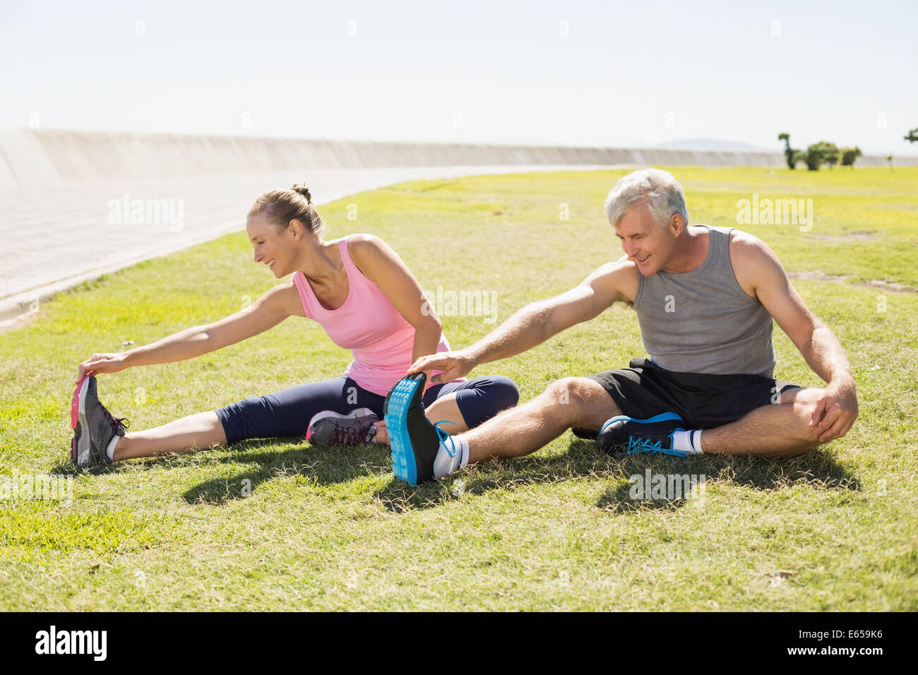 Fit Mature Couple Warming Up On The Grass Stock Photo Alamy