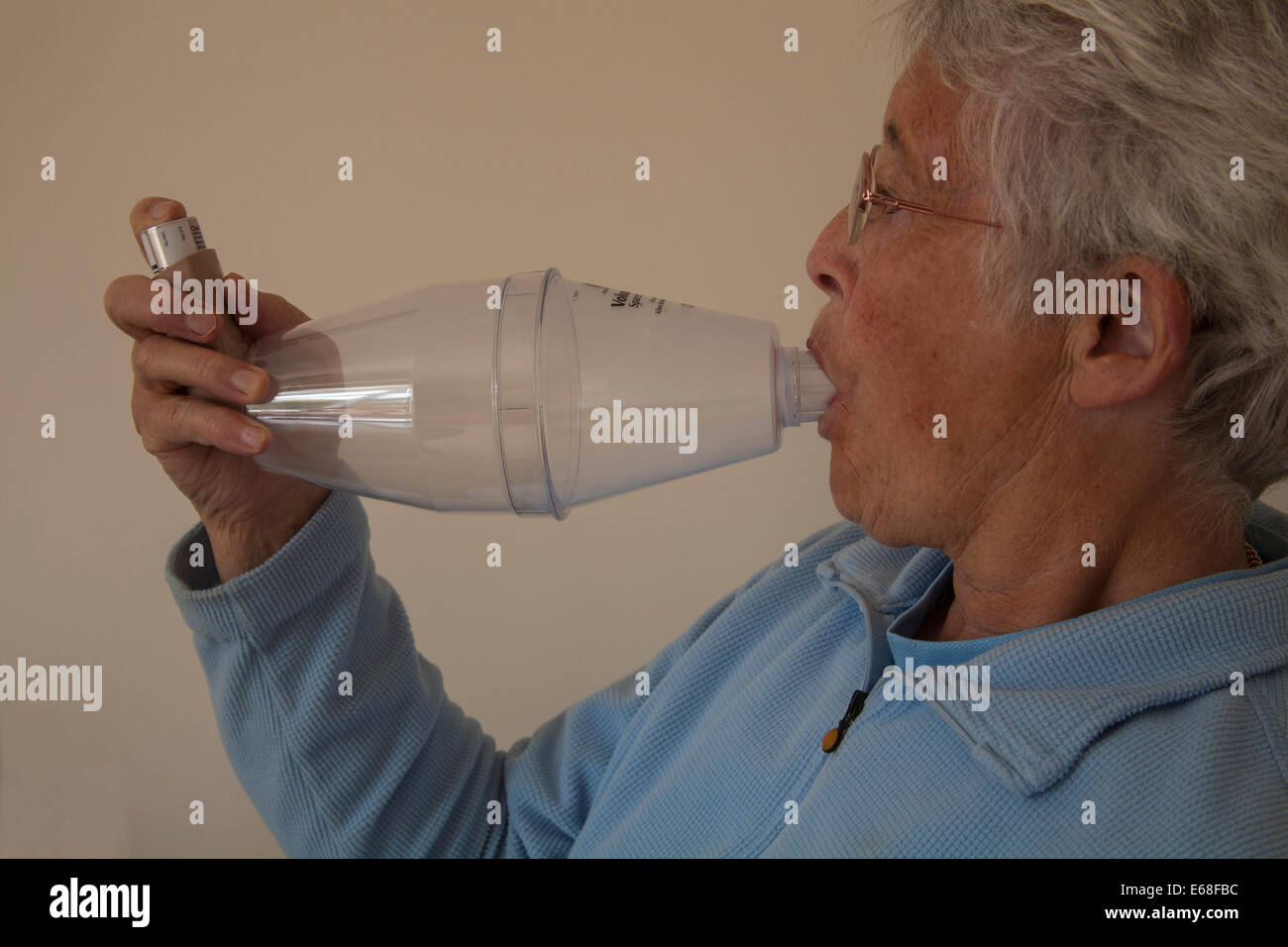 Elderly asthmatic woman using a Volumatic spacer device for steroid