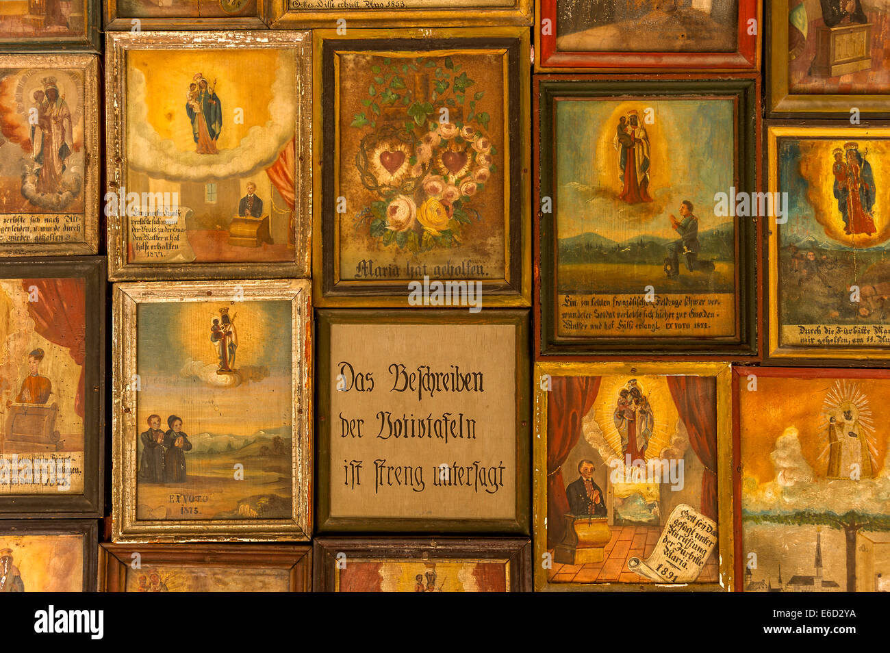 Old votive offerings in the cloister around the Shrine of Our Lady of