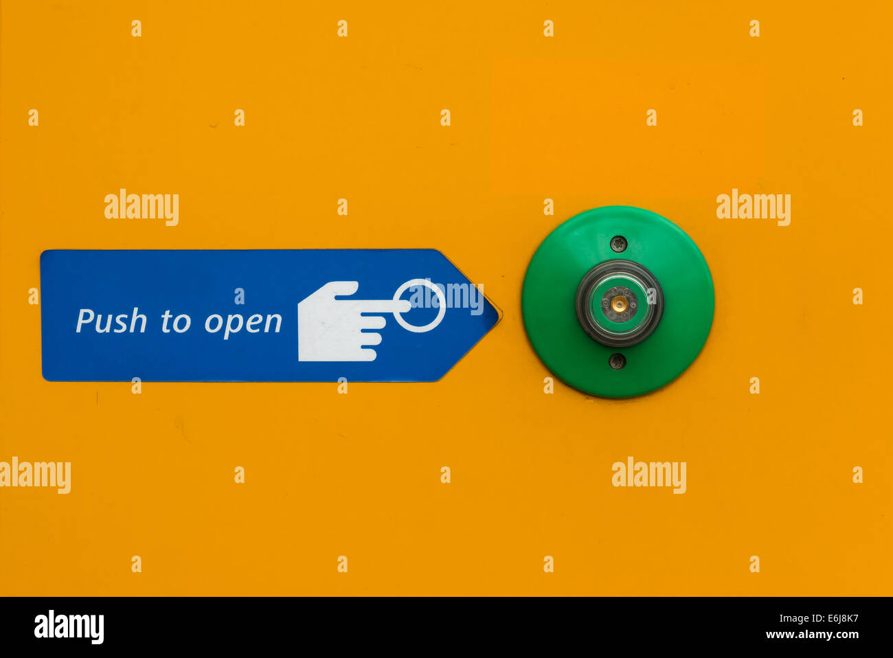 Door open push button in green with instructions to open Stock Photo