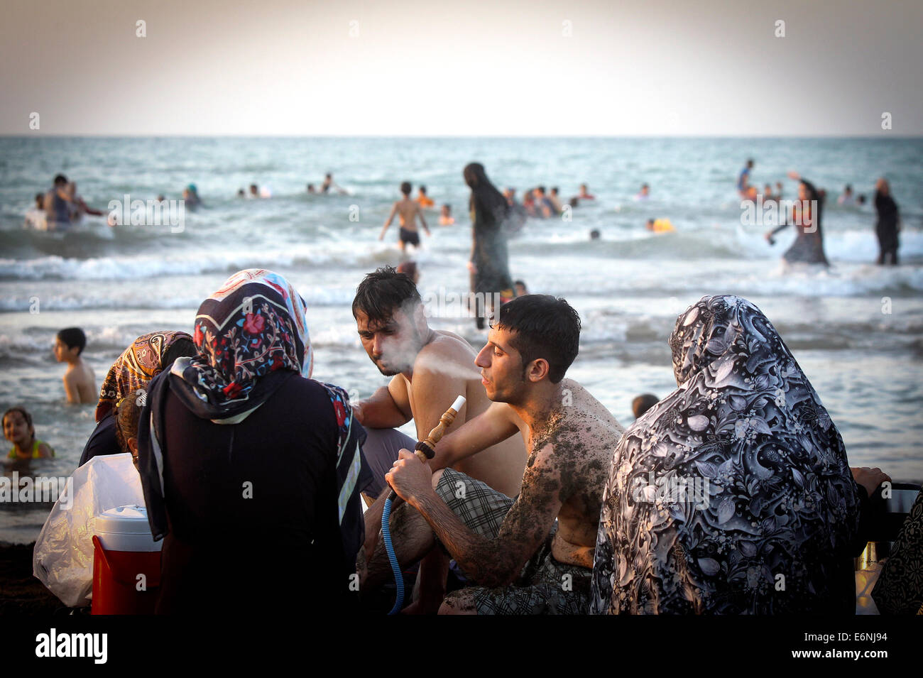 140828-tehran-aug-28-2014-xinhua-a-man-smokes-hookah-at-the-beach-E6NJ94.jpg