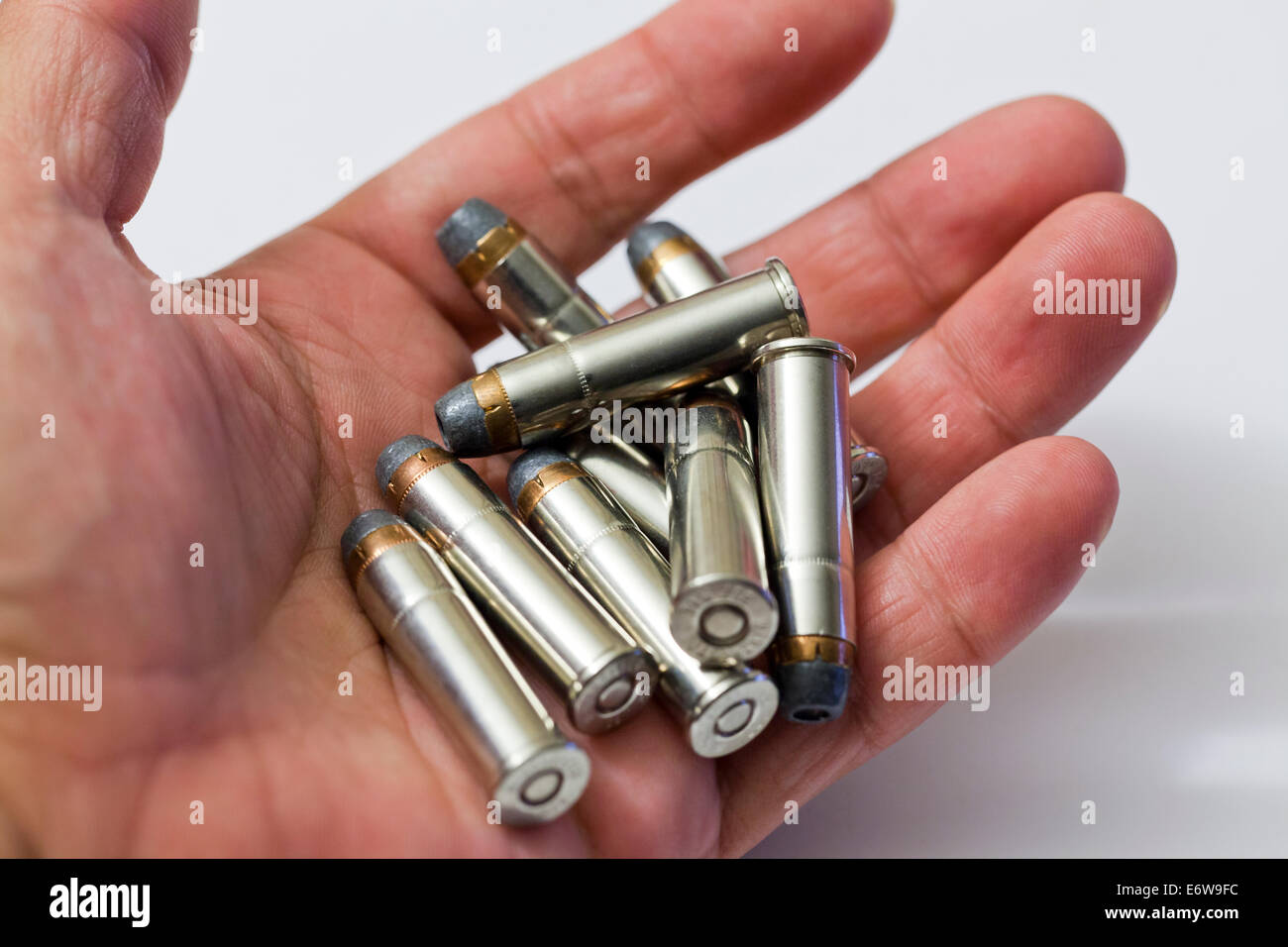 Man holding handful of Winchester 357 magnum hollow point bullets Stock