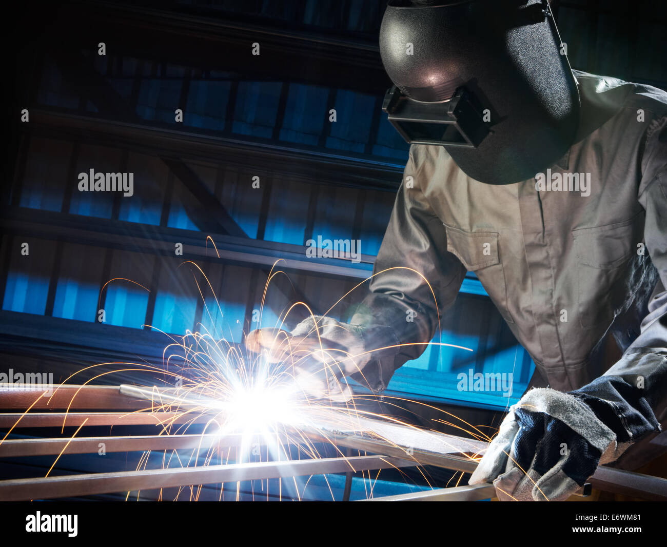 http://c8.alamy.com/comp/E6WM81/man-welding-in-workshop-with-safety-precaution-E6WM81.jpg
