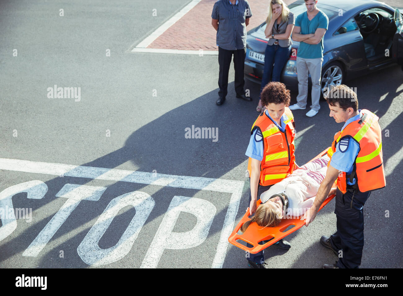 Paramedics carrying patient on stretcher Stock Photo, Royalty Free