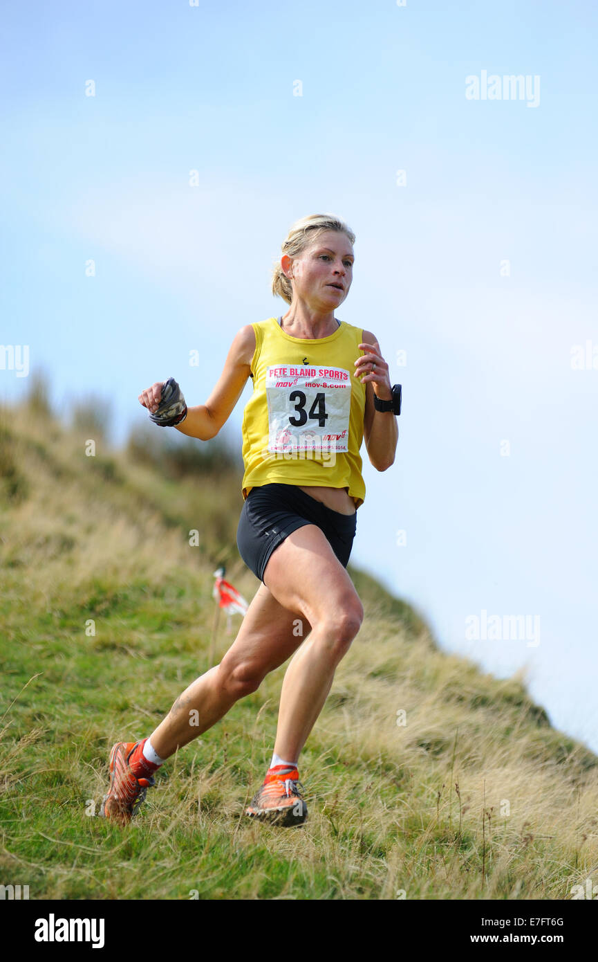 Lady fell runner running downhill at a fell race Stock Photo, Royalty