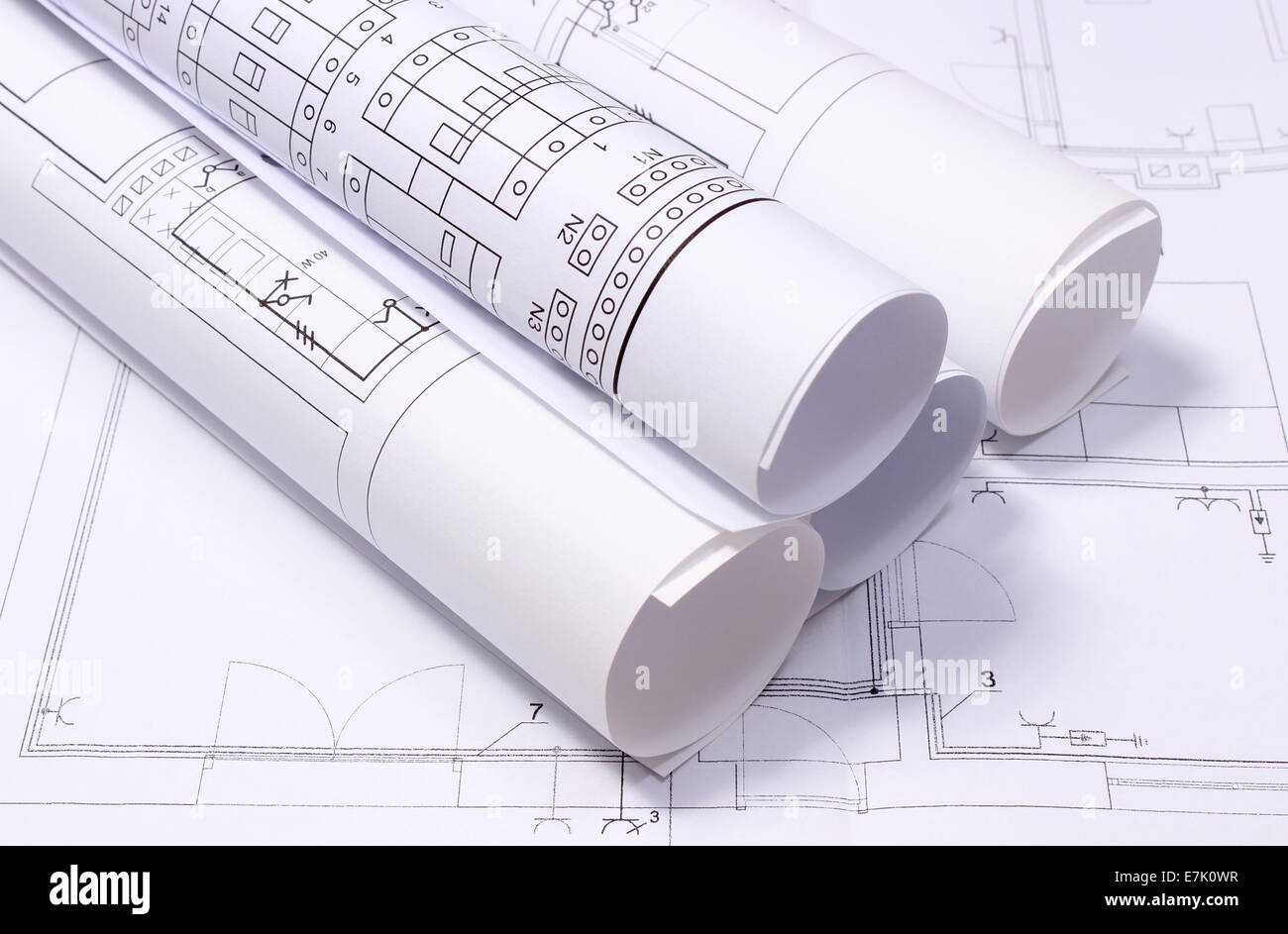rolled electrical diagrams lying on construction drawing of house drawings for the projects engineer jobs rolled electrical diagrams lying on construction drawing of house drawings for the projects engineer jobs