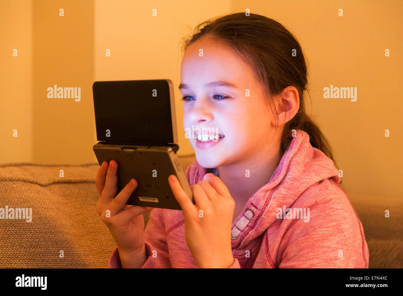 young girl using Nintendo DS games console Stock Photo, Royalty Free