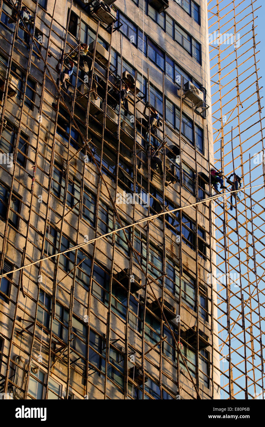 Chinese construction workers on bamboo scaffolding, Hong Kong, China