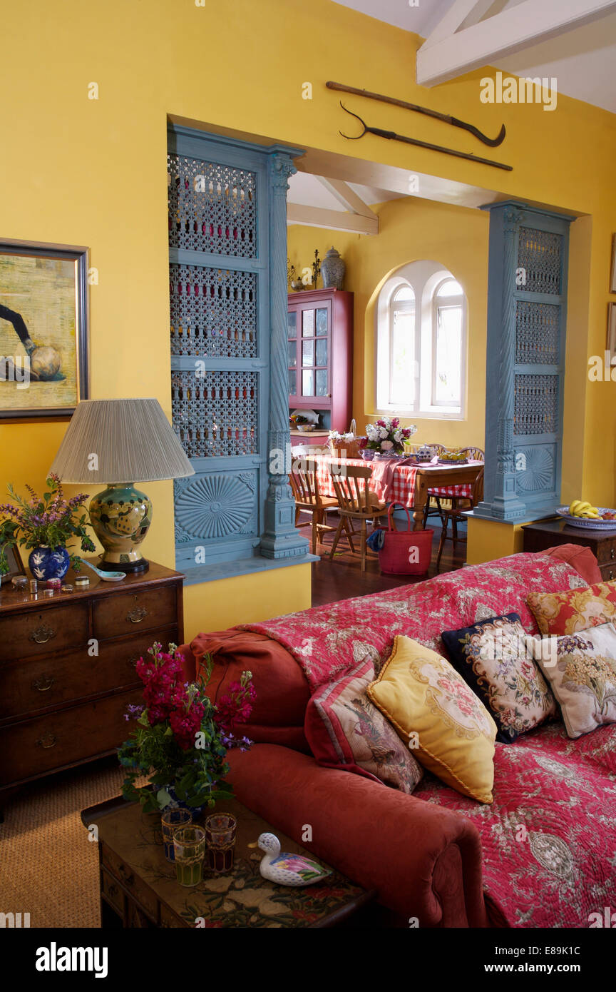 Cushions and pink quilted throw on sofa in front of doorway with Cushions and pink quilted throw on sofa in front of doorway with