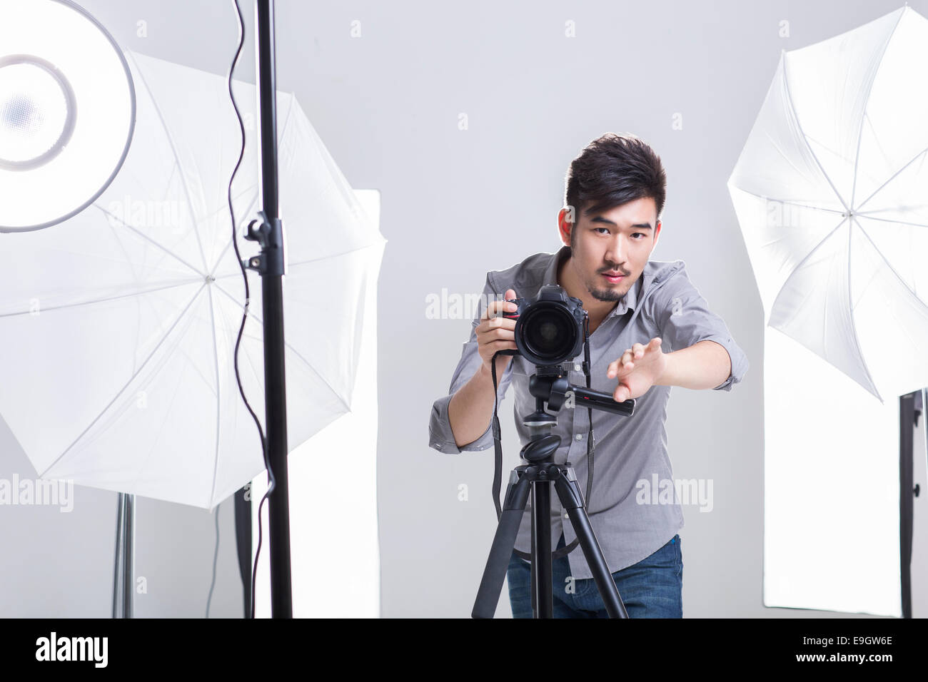 Photographer taking picture in studio Stock Photo, Royalty Free Image