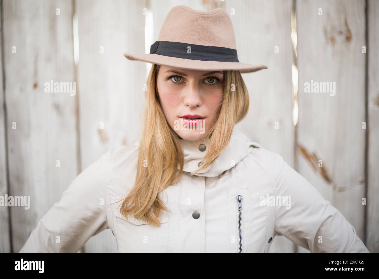 Portrait Of A Cheerful Blonde Model Posing With Hand On Hips Stock