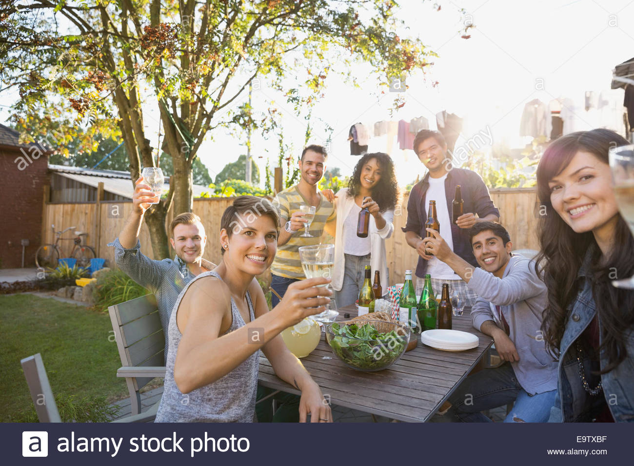 Portrait Of Friends Toasting Drinks At Backyard Barbecue Stock