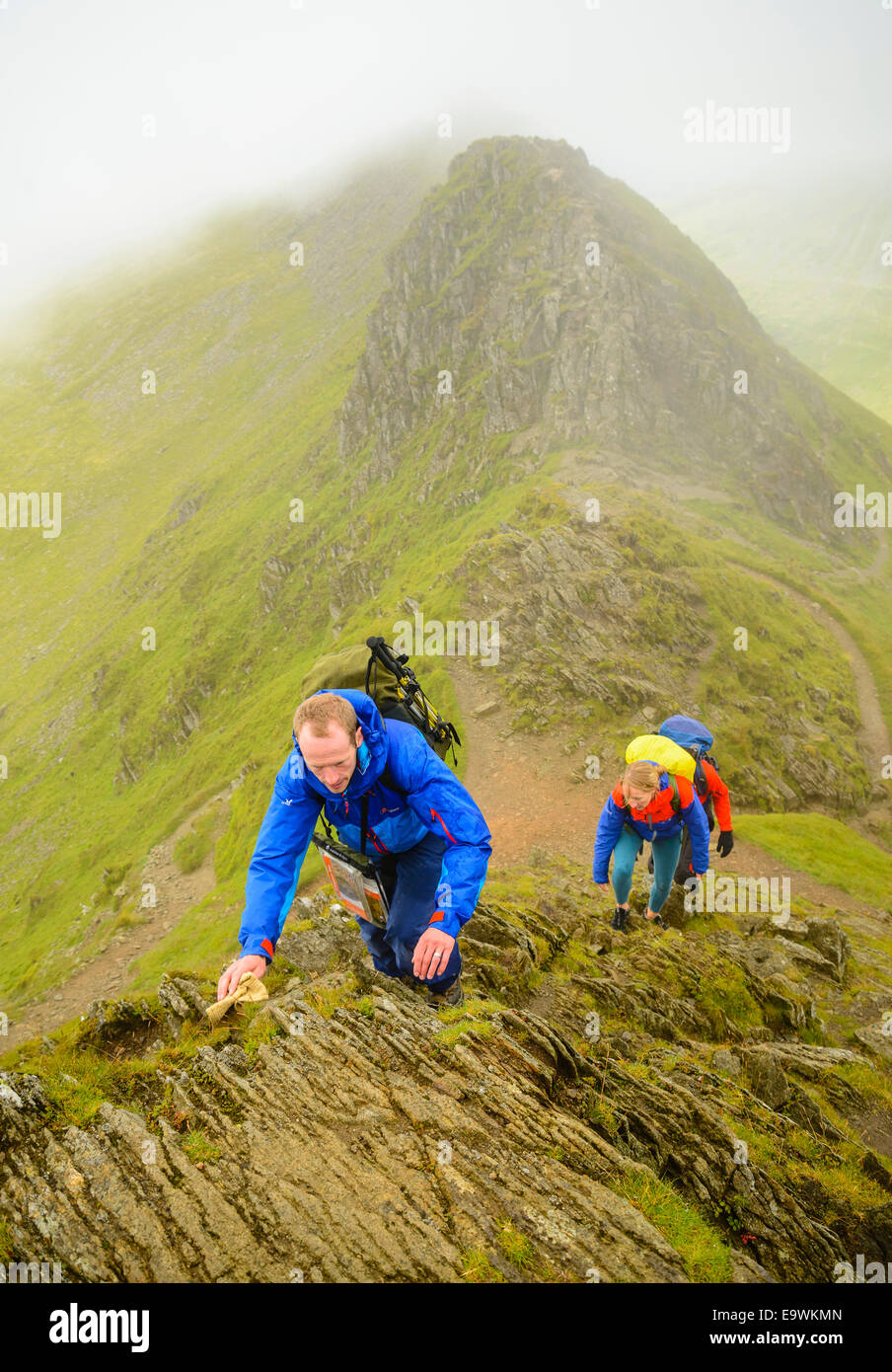 Walkers climbing Helvellyn from Striding Edge in the Lake District