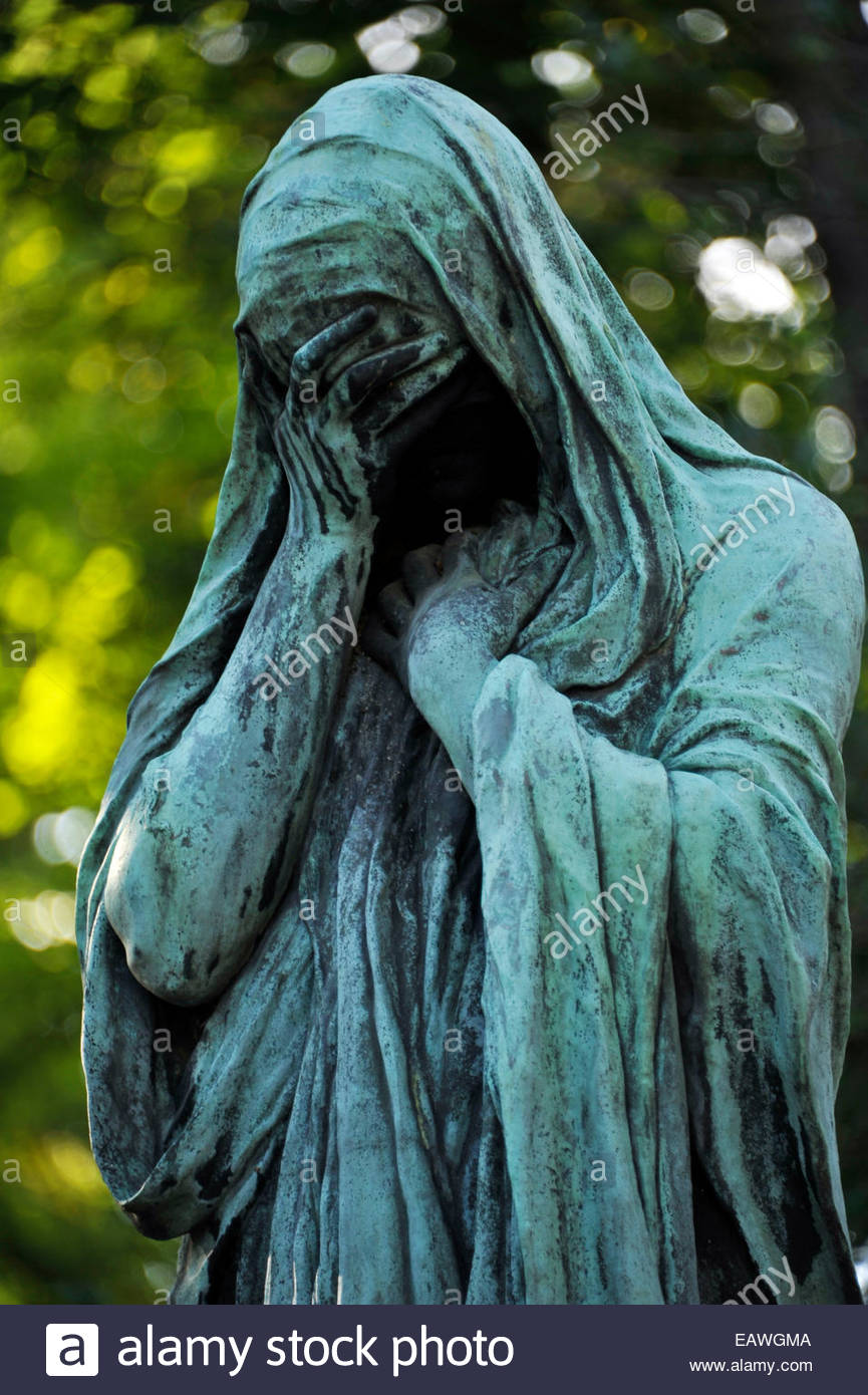 Weeping woman statue stands above grave in Pere Lachaise Cemetery Stock