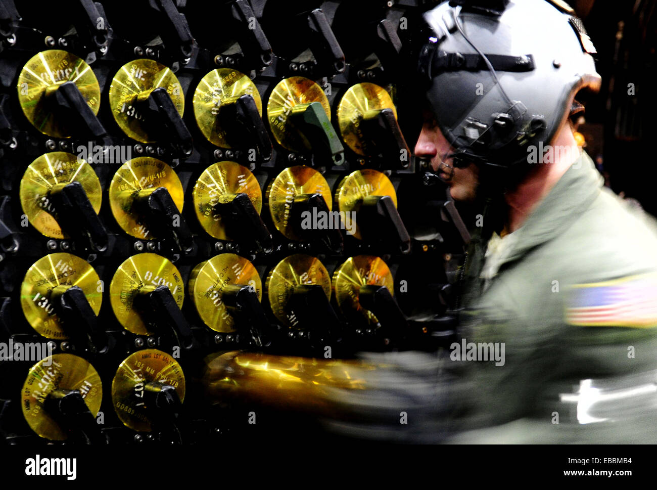 A U.S. Air Force aerial gunner on a AC130H Spectre Gunship loads Stock