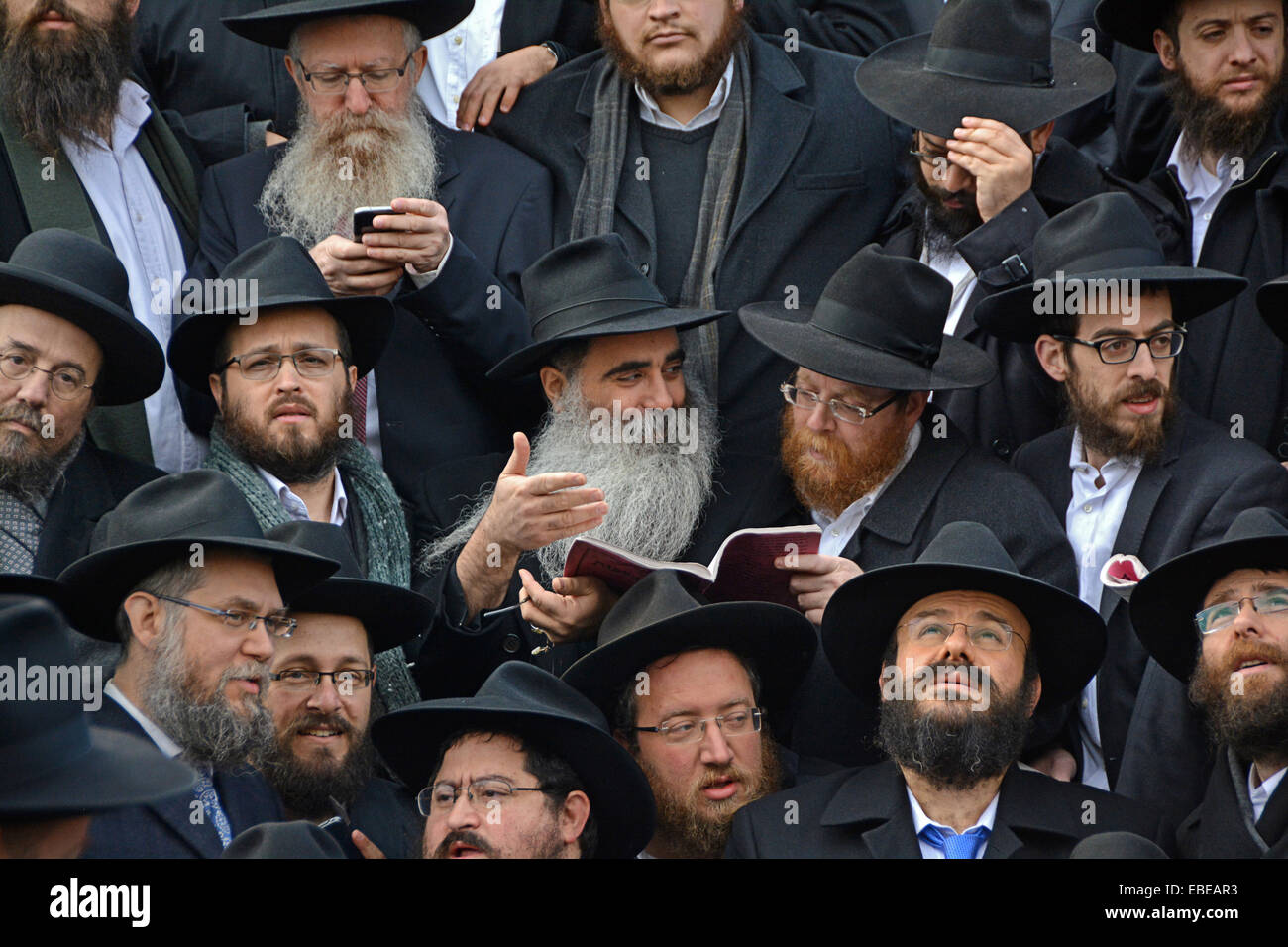 A group of orthodox rabbis discussing Jewish law at a group photo at