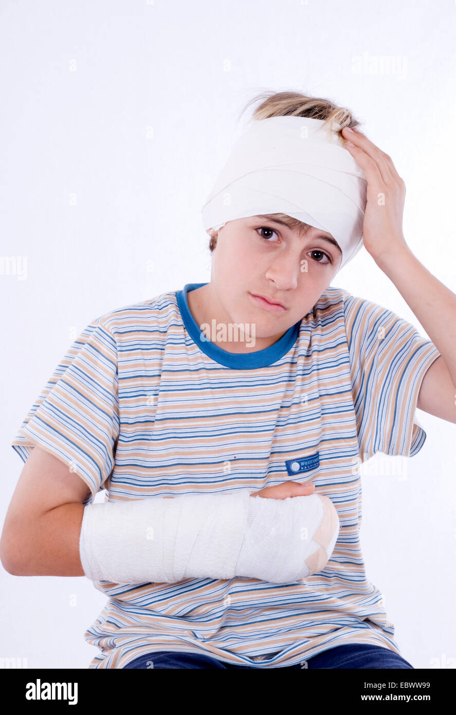 boy with arm in plaster and bandage on head Stock Photo, Royalty Free